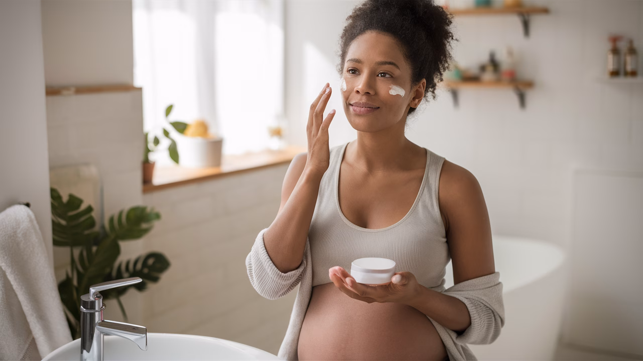 Pregnant woman applying skincare